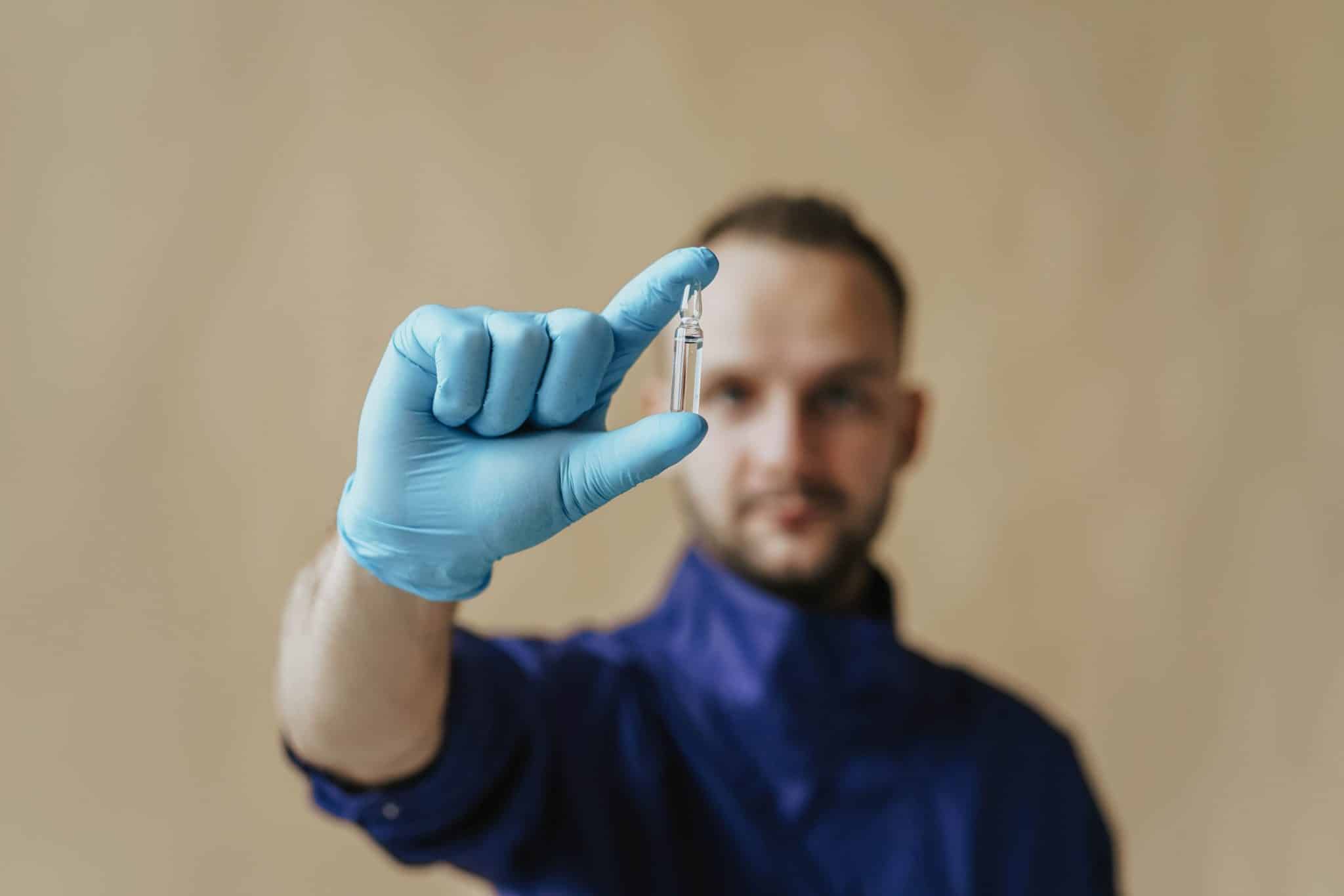 A man holding a test tube for research purpose
